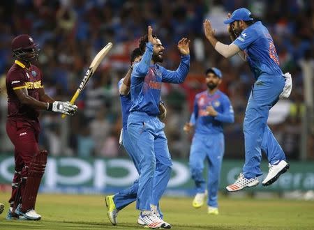 Cricket - West Indies v India - World Twenty20 cricket tournament semi-final - Mumbai, India - 31/03/2016. India's Virat Kohli (C) celebrates with his teammates after taking the wicket of West Indies Johnson Charles. REUTERS/Danish Siddiqui