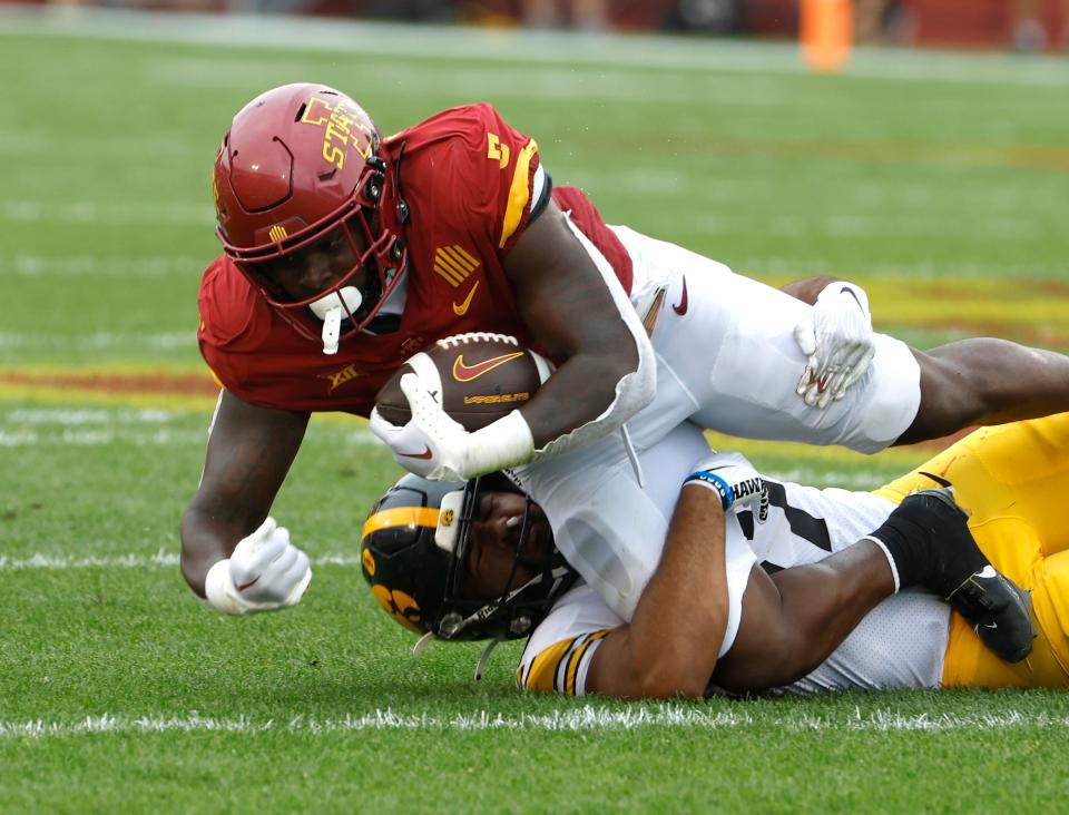 Iowa State RB Cartevious Norton (#5) is tackled by Iowa LB Kyler Fisher (#37) in Saturday's Cy-Hawk game at Jack Trice Stadium.