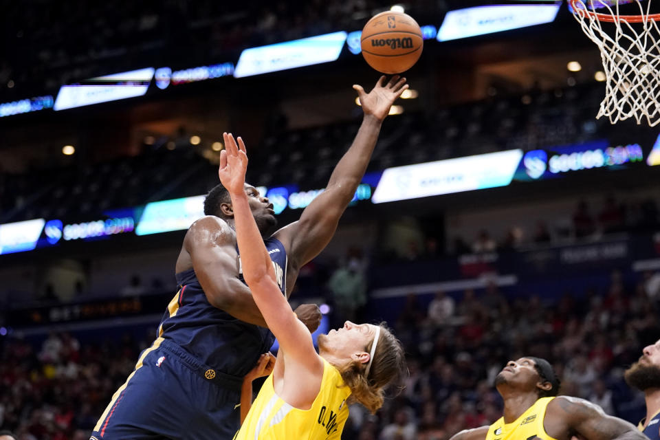 New Orleans Pelicans forward Zion Williamson drives to the basket against Utah Jazz forward Kelly Olynyk in the first half of an NBA basketball game in New Orleans, Sunday, Oct. 23, 2022. (AP Photo/Gerald Herbert)