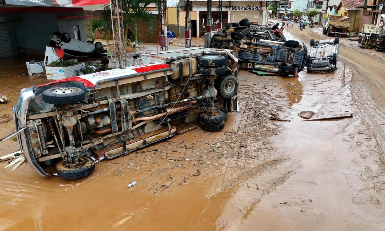<span>Vehicles overturned on a street covered by mud after heavy rains hit Mimoso do Sul in Espírito Santo state.</span><span>Photograph: Wender/Espírito Santo state government/AFP/Getty Images</span>