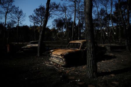 FILE PHOTO: Burnt cars are seen following a wildfire in the village of Mati, near Athens, Greece, July 27, 2018. REUTERS/Costas Baltas