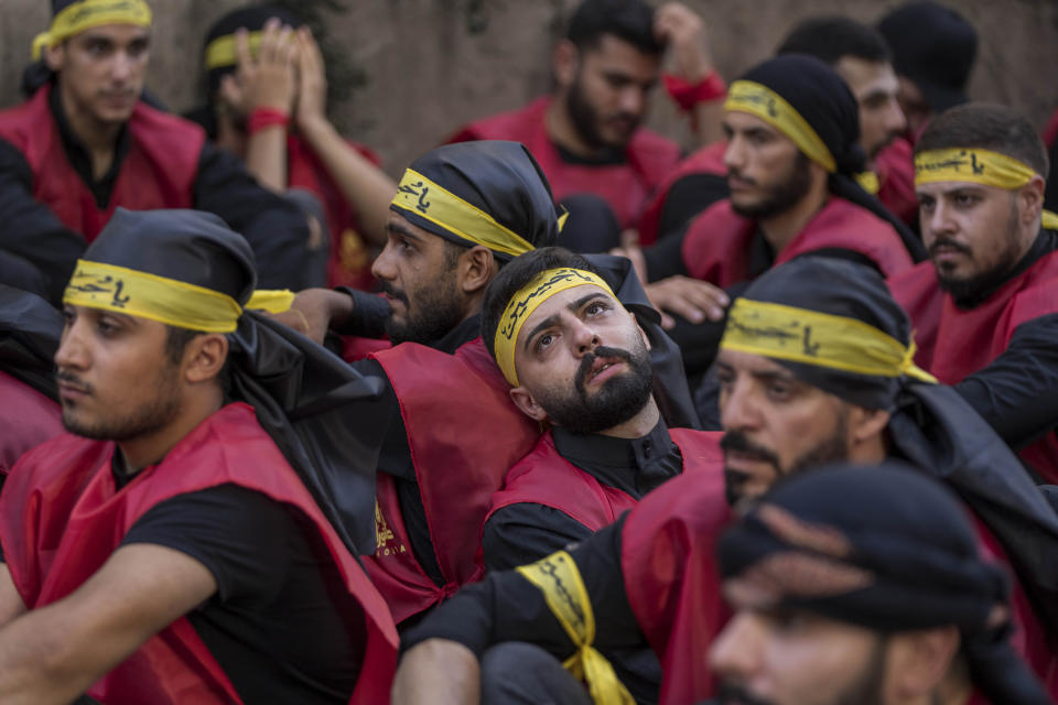 Hezbollah supporters in a sermon listen to the story of Ashoura, the Shiite Muslim commemoration marking the death of Imam Hussein, the grandson of the Prophet Muhammad, at the Battle of Karbala in present-day Iraq in the 7th century, in the southern suburbs of Beirut, Lebanon, Saturday, July 29, 2023. The leader of Lebanon's Hezbollah militant group said Saturday that if the governments of Muslim-majority nations do not take action against countries that allow the desecration of the Quran, it is the responsibility of Muslims to "punish" those who facilitate attacks on the Islamic holy book. (AP Photo/Hassan Ammar)