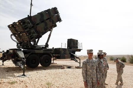 U.S. soldiers stand beside a U.S. Patriot missile system at a Turkish military base in Gaziantep, southeastern Turkey, October 10, 2014. REUTERS/Osman Orsal