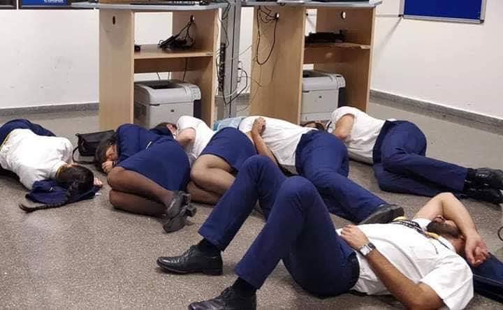 Six Ryanair crew members sleep on the floor of a crew room after their flight was canceled. (Photo: Facebook)