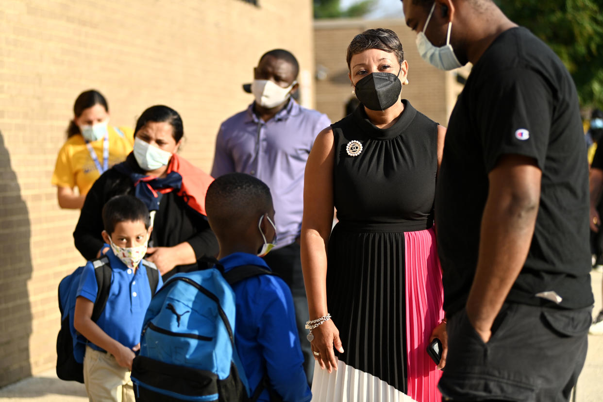 Monica Goldson, CEO of Prince George's County Public Schools, greets children, teachers and parents on the first day of school at Deerfield Run Elementary in Laurel, Md., on Sept. 5, 2021.