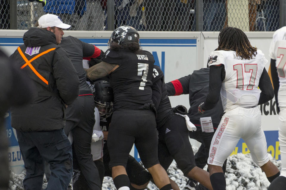 FILE - In this Nov. 30, 2019, file photo, players converge during a post-game scuffle at the end of an NCAA college football game between UNLV and Nevada in Reno, Nev. The Las Vegas Raiders were the first team to play inside Allegiant Stadium. But the UNLV Rebels will be the first team to play with fans inside the $2 billion dollar venue, when they host in-state rival Nevada on Saturday, Oct. 31, 2020. (AP Photo/Tom R. Smedes, File)