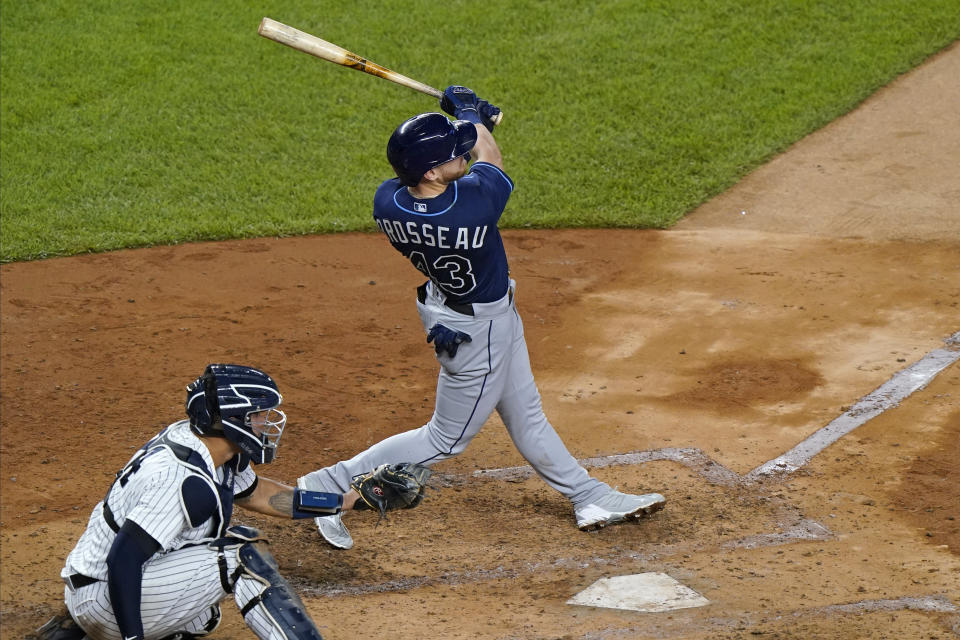 Tampa Bay Rays Michael Brosseau follows through on a solo home run, his second of the night, during the fourth inning of a baseball game against the New York Yankees, Wednesday, Sept. 2, 2020, at Yankee Stadium in New York. Yankees catcher Gary Sanchez is behind the plate. (AP Photo/Kathy Willens)