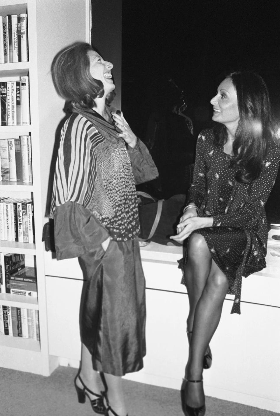 diane von furstenberg and gail sheehy chatting at party