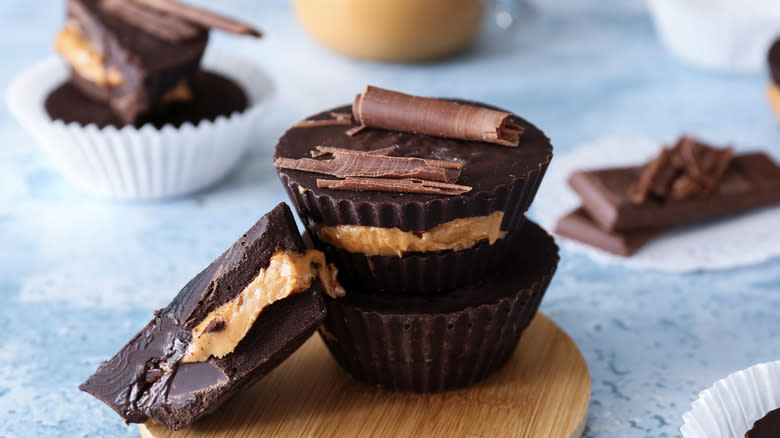 Chocolate peanut butter cups stacked with chocolate curls
