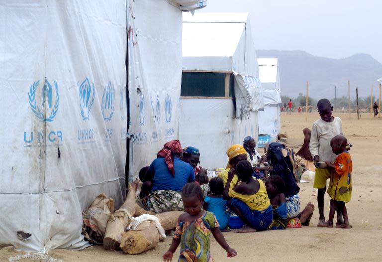 Nigerian refugees sit by a United Nation Refugee Agency tent in the Minawao camp in Cameroon, March 29, 2014