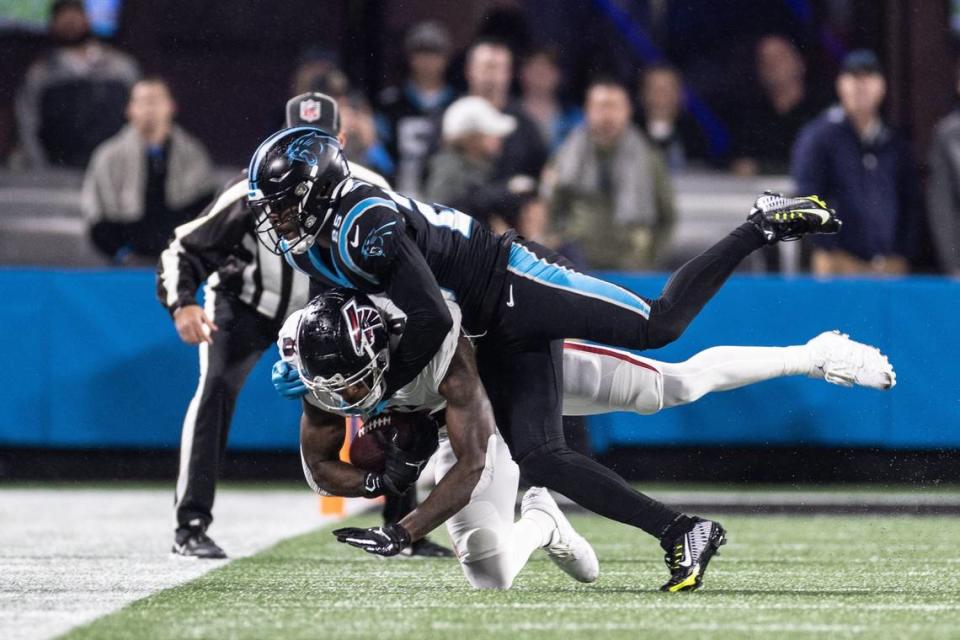 Atlanta Falcons tight end Kyle Pitts, bottom, is tackled by Carolina Panthers safety Xavier Woods on Thursday, November 10, 2022.