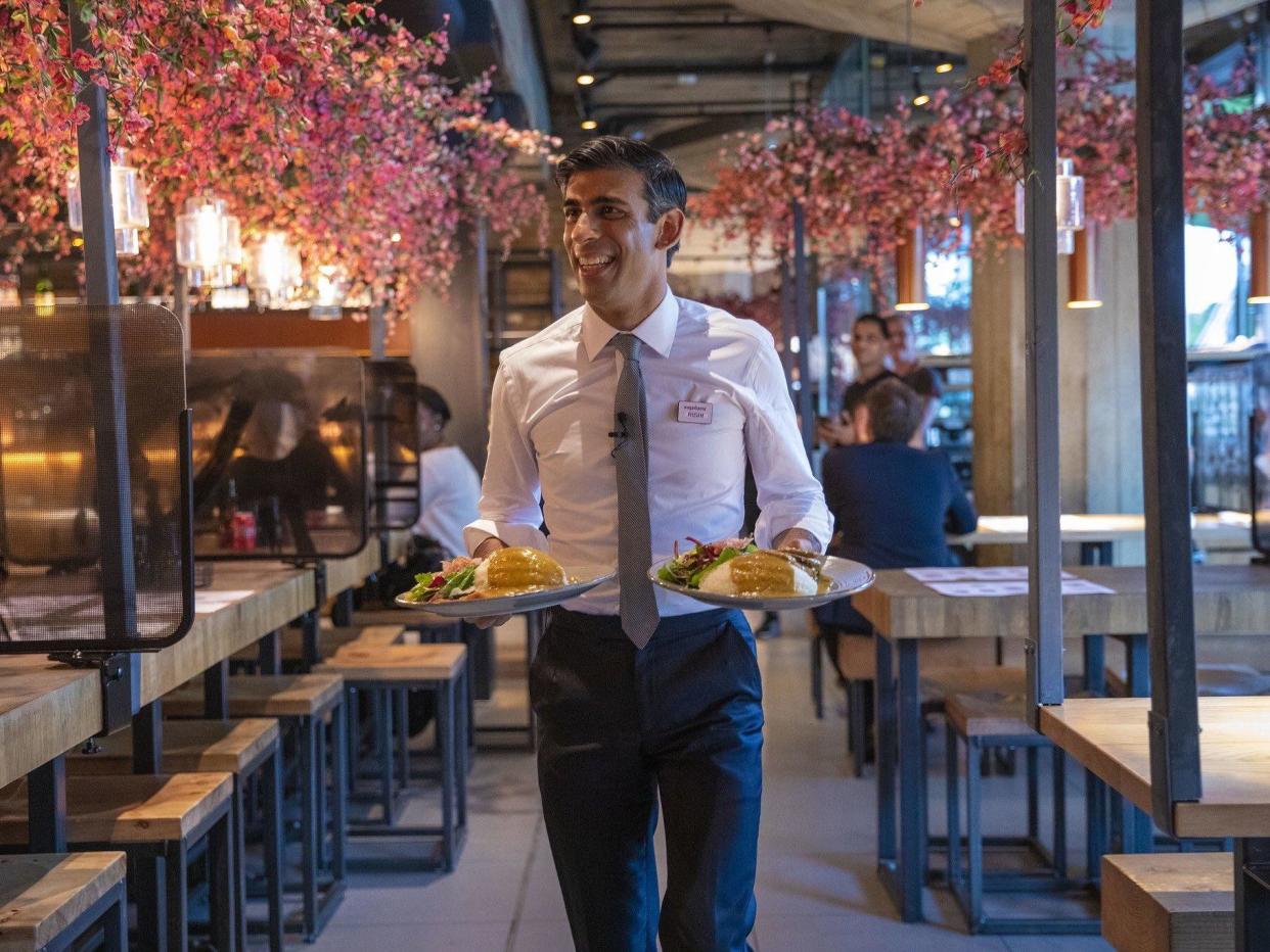 Chancellor Rishi Sunak serves food to customers in Wagamama, after announcing meal discounts for restaurant patrons in a bid to help the industry recover from the coronavirus crisis: Rishi Sunak