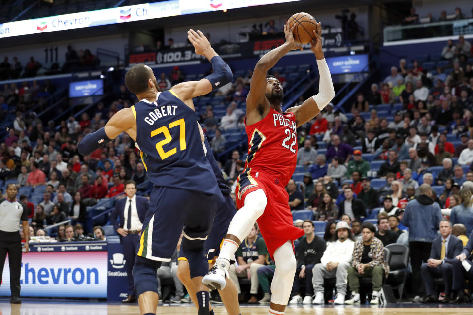 New Orleans Pelicans forward Derrick Favors (22) shoots over Utah Jazz center Rudy Gobert (27) in the first half of an NBA basketball game in New Orleans, Monday, Jan. 6, 2020. (AP Photo/Tyler Kaufman)
