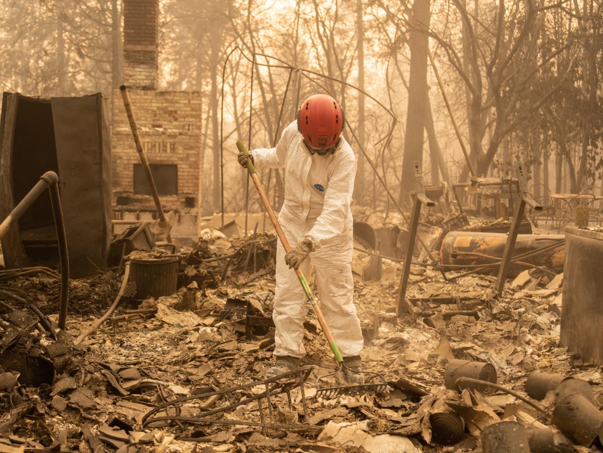 A member of the Tuolumne County Sheriff's Search &amp; Rescue Team looks for human remains at a burned home in Paradise. (Photo: Cayce Clifford for HuffPost)
