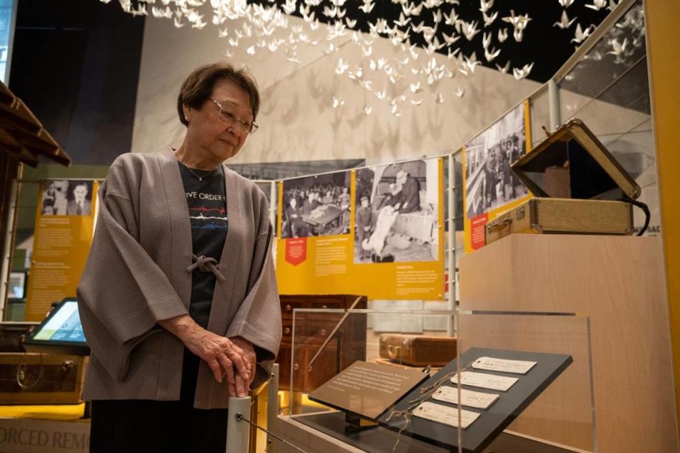 Christine Umeda stands next to the numbered luggage tags her husband’s family had to wear when they we sent to the incarceration camps Wednesday, March 1, 2023, at the new Uprooted: An American Story exhibition inside of California Museum in Sacramento. Umeda said, “ This is the power of the presidency, and although is was misguided it did lead to a really unconstitutional period in our time, where we were unjustly incarcerated.” Uprooted tells the story of the Japanese Americans incarceration after President Franklin D. Roosevelt signed Executive Order 9066 that forcibly removed 120,000 ethnic Japanese from the west coast during WWII.