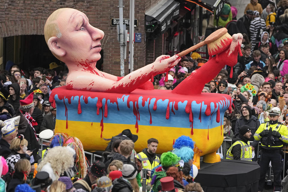 A carnival float depicts Russia's President Vladimir Putin taking a blood bath during the traditional carnival parade in Duesseldorf, Germany, on Monday, Feb. 20, 2023. The foolish street spectacles in the carnival centers of Duesseldorf, Mainz and Cologne, watched by hundreds of thousands of people, are the highlights in Germany's carnival season on Rosemonday. (AP Photo/Martin Meissner)