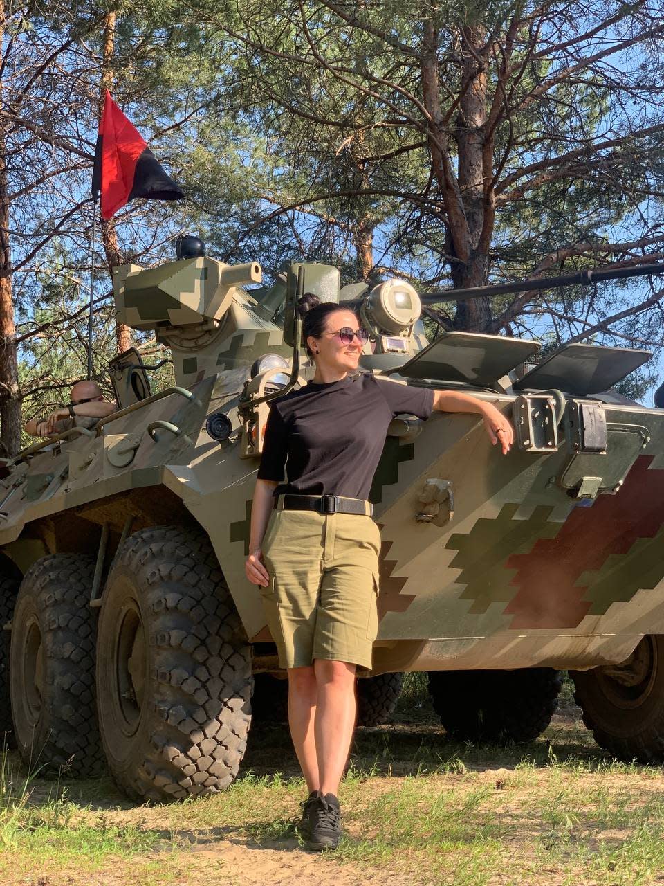 Woman posing in front of tank 