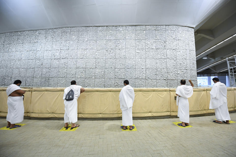 Muslim pilgrims cast stones at a pillar in the symbolic stoning of the devil, the last rite of the annual hajj, and the first day of Eid al-Adha, in Mina near the holy city of Mecca, Saudi Arabia, Friday, July 31, 2020. The global coronavirus pandemic has cast a shadow over every aspect of this year's pilgrimage, which last year drew 2.5 million Muslims from across the world to Mount Arafat, where the Prophet Muhammad delivered his final sermon nearly 1,400 years ago. Only a very limited number of pilgrims were allowed to take part in the hajj amid numerous restrictions to limit the potential spread of the coronavirus. (Saudi Ministry of Media via AP)