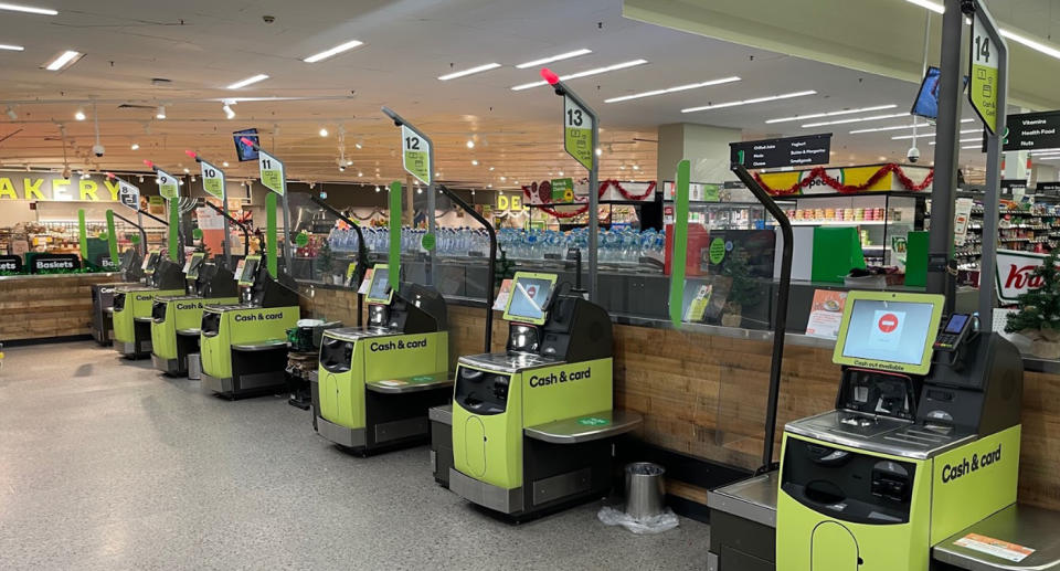 The lime green 'Cash and Card' self-serve registers at Woolworths. 