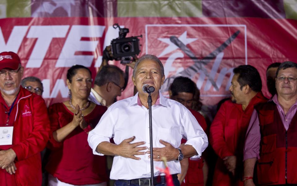 Salvador Sanchez Ceren, presidential candidate, current vice president for the ruling Farabundo Marti National Liberation Front (FMLN) gestures during a demonstration in San Salvador, El Salvador, Sunday, Feb. 2, 2014. El Salvador's electoral tribunal said late Sunday that with about 58 per cent of the votes counted, Vice-President Salvador Sanchez had 49 per cent in his bid to extend the rule of the Farabundo Marti National Liberation Front, the party of former civil war guerrillas that won the presidency for the first time in 2009. Sanchez was just under the 50 per cent plus one vote he needed to win outright, but election tribunal chief Eugenio Chicas predicted the candidate would fall short and have to face a runoff. San Salvador Mayor Norman Quijano was second with nearly 39 per cent as the candidate of the long-governing conservative Nationalist Republican Alliance, known as ARENA. (AP Photo/Esteban Felix)