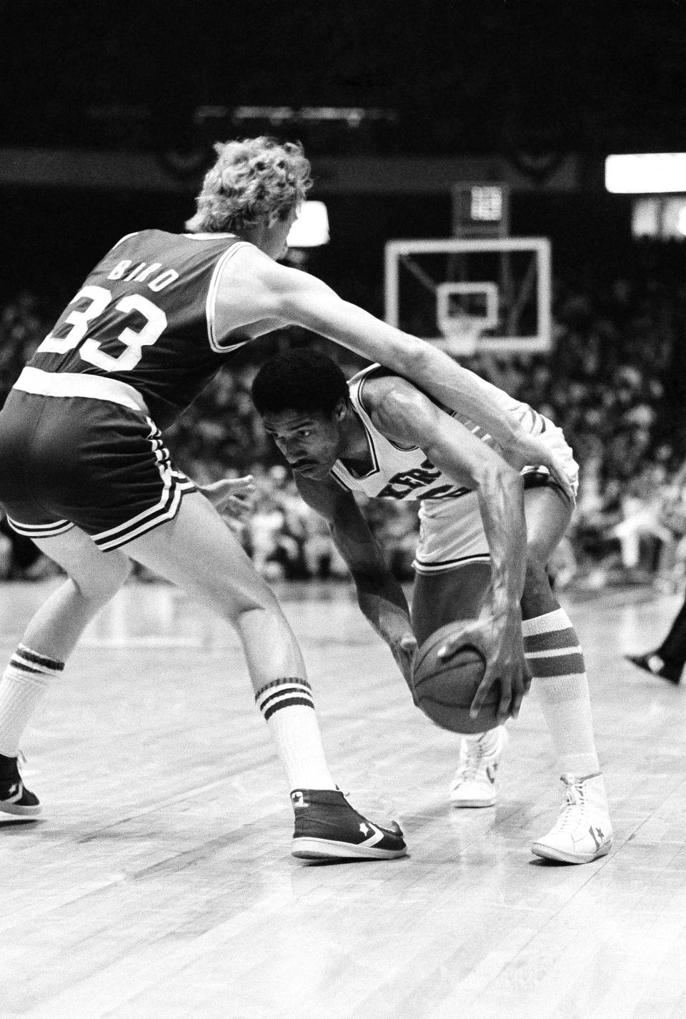 Sixers Julius Erving, right, ducks under Boston Celtics Larry Bird’s arm on his way to two of his 30 points in Game 4 of the best of seven NBA semi-final playoff series at Philadelphia, April 26, 1980. Philadelphia won the game 102-90 to go up 3 games to 1. AP Photo