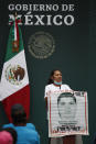 Maria Martinez, mother of Miguel Angel Hernandez Martinez, stands with a picture of her missing son as she addresses government representatives and relatives of 43 missing students from the Rural Normal School of Ayotzinapa, during a presentation of the ongoing investigations on the sixth anniversary of the students’ enforced disappearance, at the National Palace in Mexico City, Saturday, Sept. 26, 2020. (AP Photo/Rebecca Blackwell)