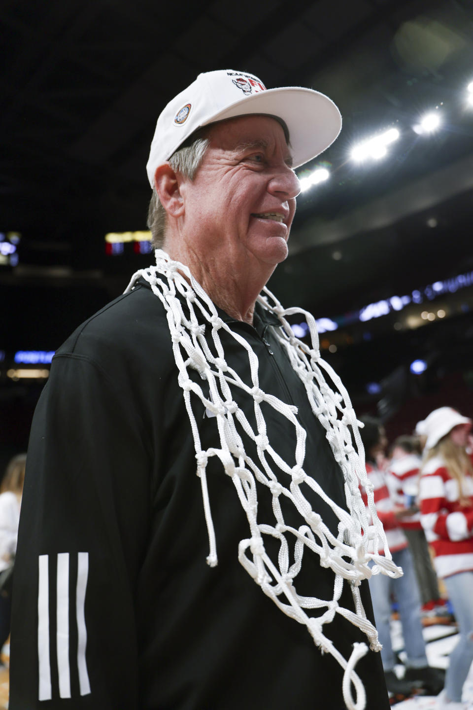 North Carolina State coach Wes Moore wears the net around his neck after the team's win against Texas in an Elite Eight college basketball game in the women's NCAA Tournament, Sunday, March 31, 2024, in Portland, Ore. North Carolina State won 76-66. (AP Photo/Howard Lao)