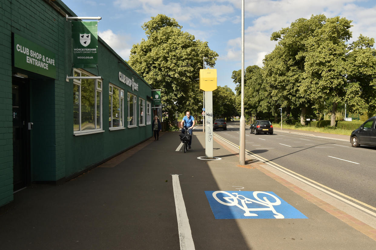 New cycle lane along New Road in Worcester from the city centre to St John's alongside Worcestershire Cricket Ground has various obstacles to navigate including a speed camera, bins and trees, all in the way of the route.  See SWNS story SWMDcycle.  June 21, 2022.  A cycle lane that is littered with obstacles including a speed camera, rubbish bins, trees and lampposts has been branded “insane”.  The barmy bike route in Worcester forces cyclists to zig-zag around numerous hazards.  On one stretch which is next to a busy main road, cyclists have to negotiate a speed camera and a lamppost which is blocking the lane.  The cycle lanes, which stretch 20 miles through Worcester, are part of a multi-million project aimed at encouraging people to cycle more.  Worcestershire County Council has installed a new segregated cycle lane along the busy New Road in Worcester as part of a pilot scheme.  But cyclists blasted the lane, saying it is “more dangerous than cycling on the road”. 