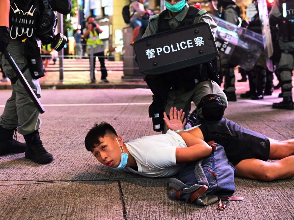 Police officers detain protesters during rally against new national security law: EPA