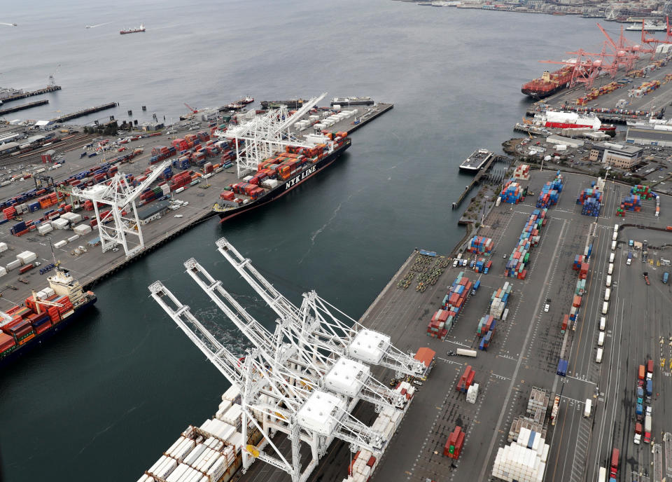 FILE- This Feb. 23, 2018, file photo shows cargo cranes at the Port of Seattle in Seattle. The path to peace in a trade war between the United States and China is getting harder to find as the world's two biggest economies pile ever more taxes on each other's products. (AP Photo/Ted S. Warren, File)