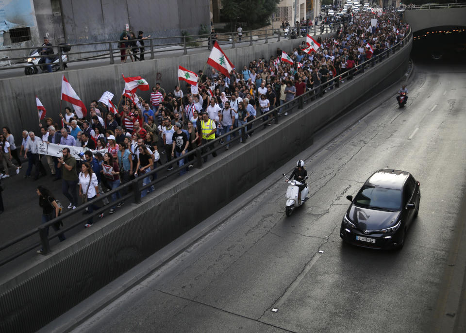 Anti-government protesters march during a protest against the central bank and the Lebanese government, in Beirut, Lebanon, Thursday, Oct. 31, 2019. Lebanese security forces were still struggling to open some roads Thursday as protesters continued their civil disobedience campaign in support of nationwide anti-government demonstrations. (AP Photo/Hussein Malla)