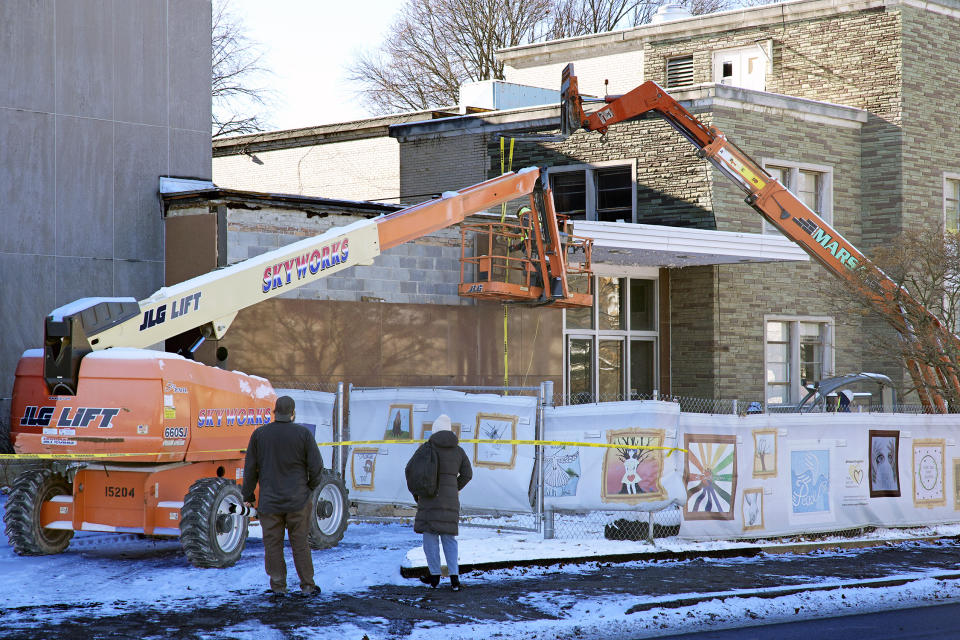 Workers begin demolition Wednesday, Jan. 17, 2023, at the Tree of Life building in Pittsburgh, the site of the deadliest antisemitic attack in U.S. history, as part of the effort to reimagine the building to honor the 11 people who were killed there in 2018. The demolition work began slowly, with crews picking away at the building's exterior. The new building will include spaces for worship and a museum, and will house community activities and an education center. (AP Photo/Gene J. Puskar)