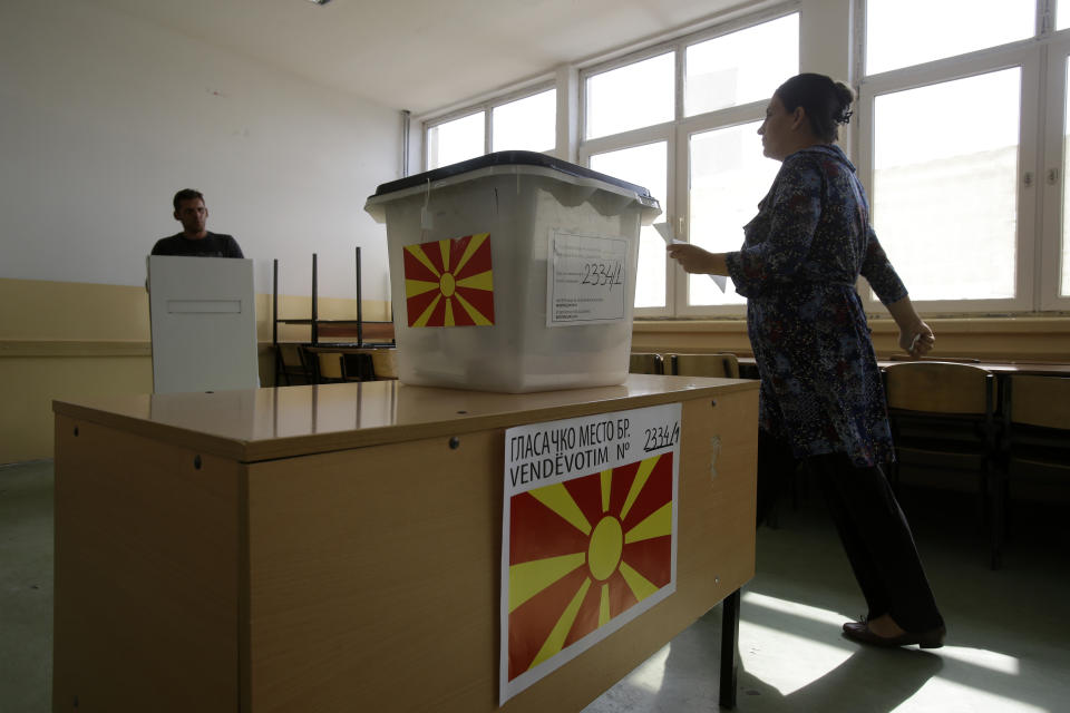 People cast their ballots at a polling station during a referendum in the village of Aracinovo, near Skopje, Macedonia, Sunday, Sept. 30, 2018. Macedonians were deciding Sunday on their country's future, voting in a crucial referendum on whether to accept a landmark deal ending a decades-old dispute with neighbouring Greece by changing their country's name to North Macedonia, to qualify for NATO membership and also pave its way toward the European Union. . (AP Photo/Boris Grdanoski)