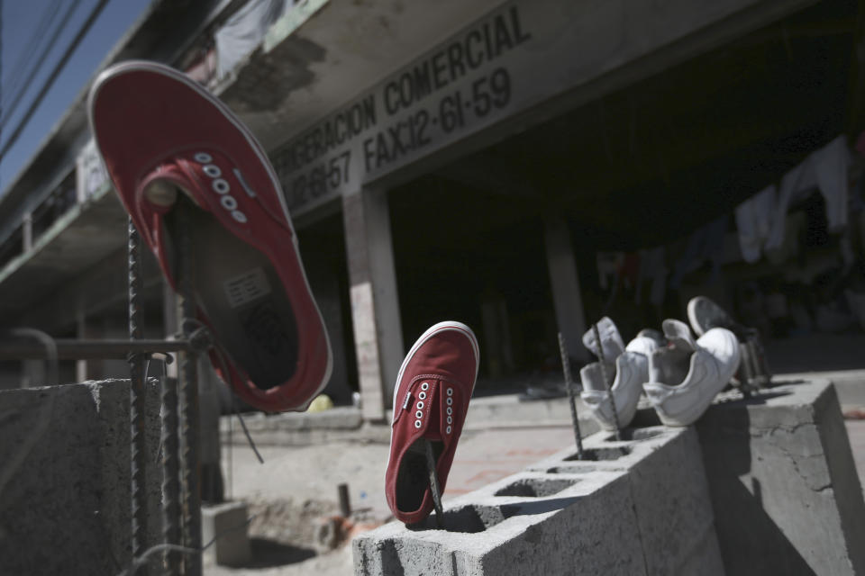 Shoes belonging to Venezuelan migrants are laid out to dry outside an abandoned building in which they are staying in Ciudad Juarez, Mexico, Thursday, March 30, 2023, days after a fire that killed dozens at an immigration detention center. (AP Photo/Christian Chavez)