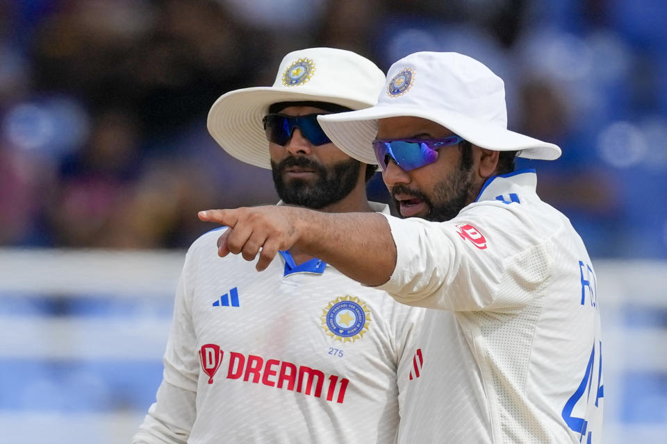 India's captain Rohit Sharma, right, talks to bowler Ravindra Jadeja on day three of their second cricket Test match against West Indies at Queen's Park in Port of Spain, Trinidad and Tobago, Saturday, July 22, 2023. (AP Photo/Ricardo Mazalan)