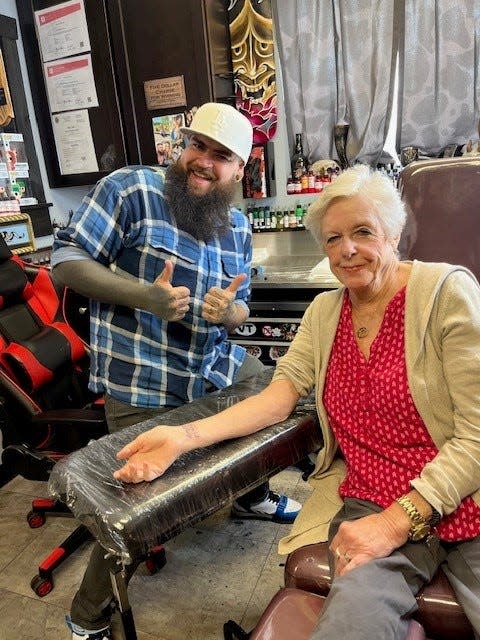 Marigrace Larabee, who is a resident at The Arbors Assisted Living in Taunton, gets a Tom Brady tribute tattoo from artist Dana Morse over at Pleasure in Pain Custom Tattoo in Taunton on Friday, Sept. 29, 2023.