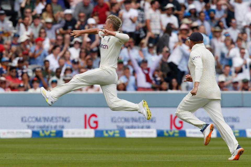 TOPSHOT - England's Sam Curran (L) celebrates after taking the wicket of India's captain Virat Kohli (R) during play on the fourth day of the second cricket Test match  between England and India at Lord's cricket ground in London on August 15, 2021. (Photo by IAN KINGTON/AFP via Getty Images)