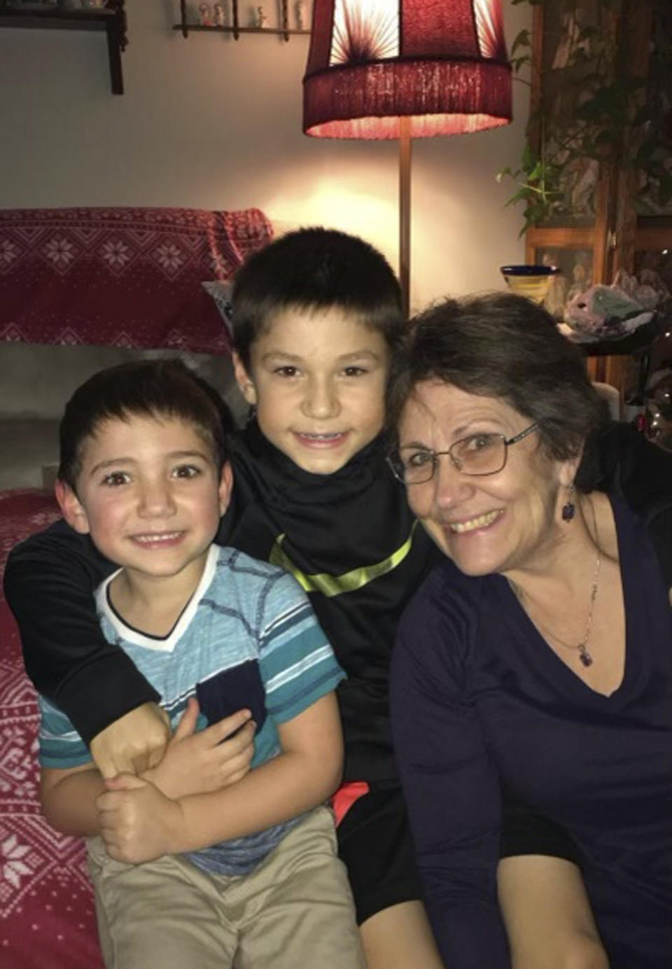 In this December 2019 photo, provided by Barbara Trout, she poses with grandsons Grayson, center, and Garrett, left, in Keizer, Ore. Trout, who suffers from asthma, was taken to ambulance to a hospital twice in September following exposure to smoke from wildfires that reached hazardous levels. (Barbara Trout via AP)