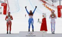 Alpine Skiing - Pyeongchang 2018 Winter Olympics - Women's Downhill - Jeongseon Alpine Centre - Pyeongchang, South Korea - February 21, 2018 - Gold medallist Sofia Goggia of Italy celebrates her victory as she is flanked by silver medallist Ragnhild Mowinckel of Norway and bronze medallist Lindsey Vonn of the U.S. during the flower ceremony. REUTERS/Leonhard Foeger