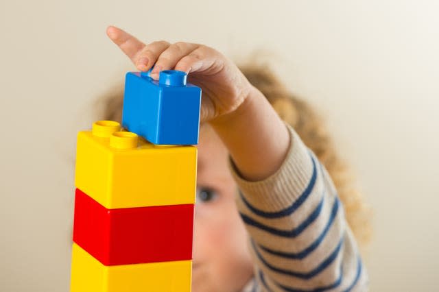 Child plays with blocks