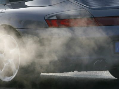 FILE PHOTO: The exhaust of a Porsche sports car is pictured in the street's traffic in Munich, December 21, 2007. REUTERS/Alexandra Beier