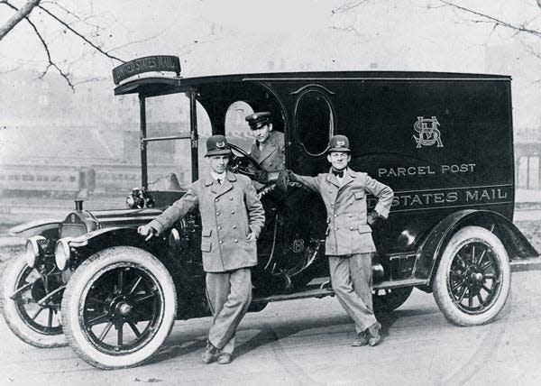 Letter carriers and driver pose with a Parcel Post truck in Baltimore, Maryland, in 1913.