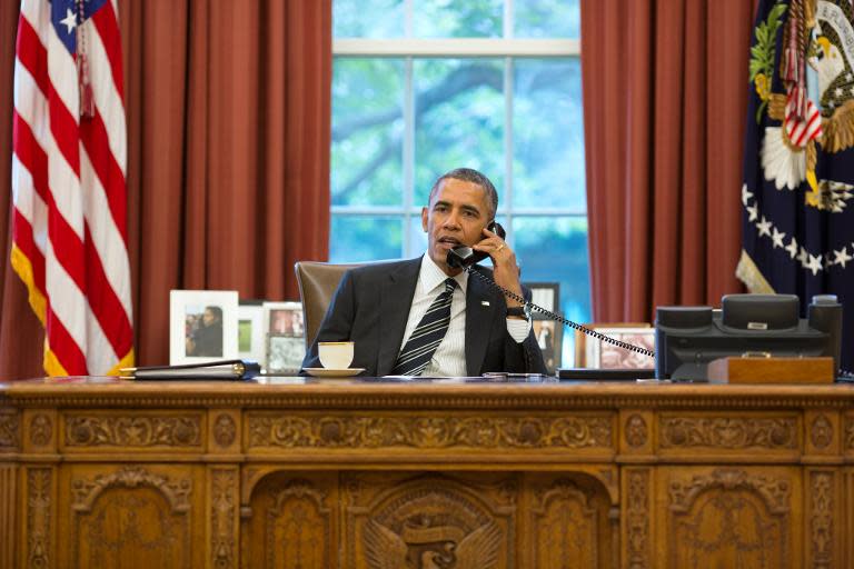 This official White House photograph released on September 27, 2013 shows President Barack Obama talks with President Hassan Rouhani of Iran during a phone call in the Oval Office