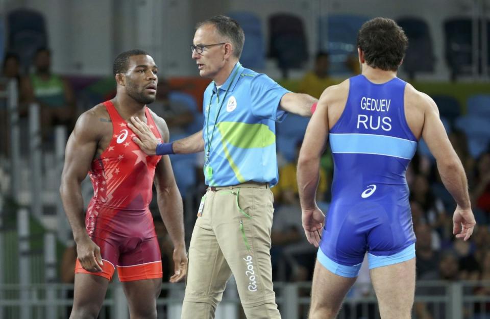 The referee sets apart Jordan Burroughs (USA) of USA and Aniuar Geduev (RUS) of Russia. REUTERS/Toru Hanai