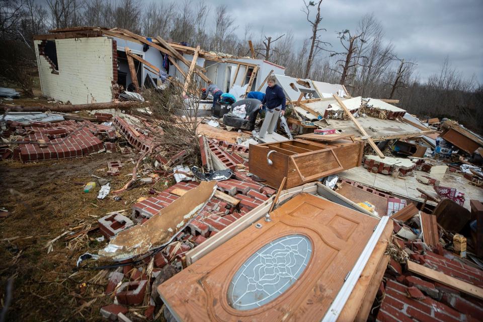 Family and friends searched through the rubble of Chris Alvey's home on Highway 69 Hartford, Kentucky after the area was hit by overnight tornados. Dec. 11, 2021