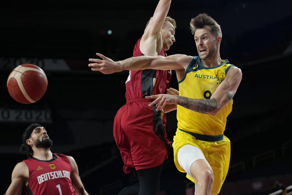 Australia's Nathan Sobey (9) drives to the basket past Germany's Niels Giffey (5) during a men's basketball preliminary round game at the 2020 Summer Olympics, Saturday, July 31, 2021, in Saitama, Japan. (AP Photo/Eric Gay)