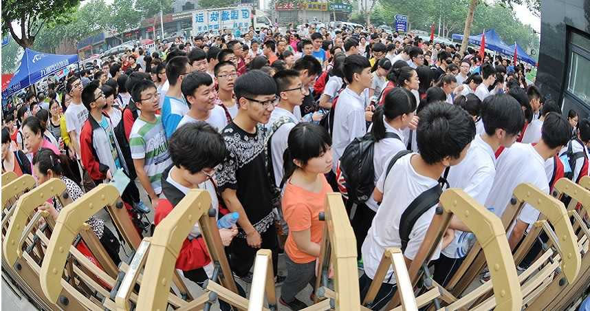 7日，大陸高考拉開序幕，南京第九中學考點，考生們結束語文考試後從「狀元門」走出。（圖／中新社）