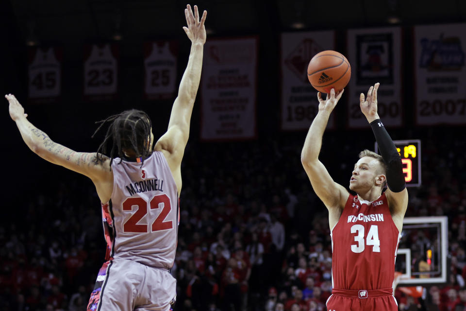 Wisconsin guard Brad Davison (34) shoots over Rutgers guard Caleb McConnell during the first half of an NCAA college basketball game Saturday, Feb. 26, 2022, in Piscataway, N.J. (AP Photo/Adam Hunger)