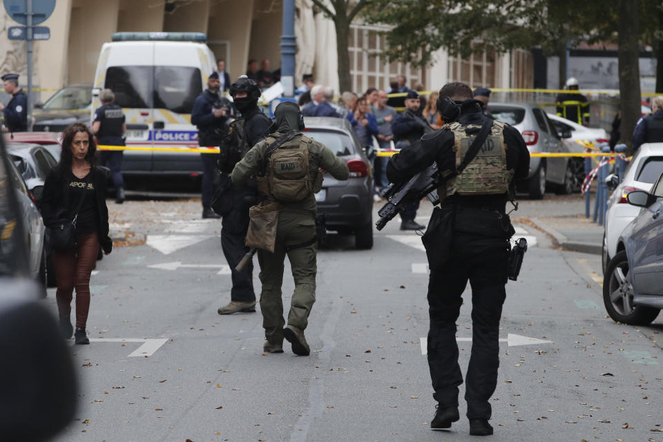 Elite police officers of the RAID squad patrol after a man armed with a knife killed a teacher and wounded two others at a high school in northern France, Friday, Oct. 13, 2023 in Arras. Antiterror prosecutors said they were leading the investigation into the attack at the Gambetta high school in the city of Arras, some 115 miles (185 kilometers) north of Paris. (AP Photo/Michel Spingler)