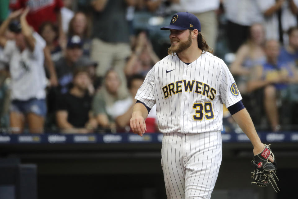 Milwaukee Brewers' Corbin Burnes reacts to a call during the fifth inning of a baseball game against the Chicago White Sox, Saturday, July 24, 2021, in Milwaukee. White Sox's Yoan Moncada was initially called safe at home but the call was changed to an out after replay review showed that he never stepped on home plate. (AP Photo/Aaron Gash)